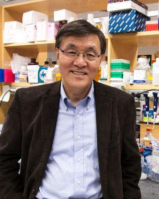 Kim Kwang Soo standing in lab
