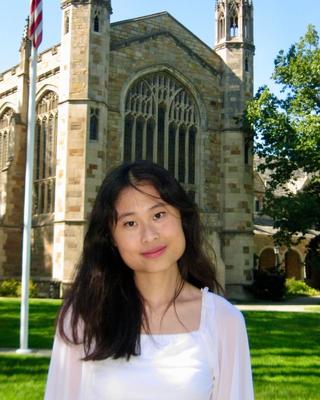 woman standing in front of an academic building