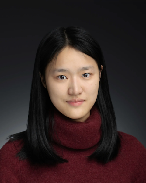 headshot of woman with dark hair in red sweater